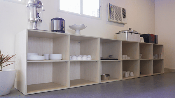 Open shelving unit of Lime Tree Hotel, Pulkit featuring tea and coffee making trays.