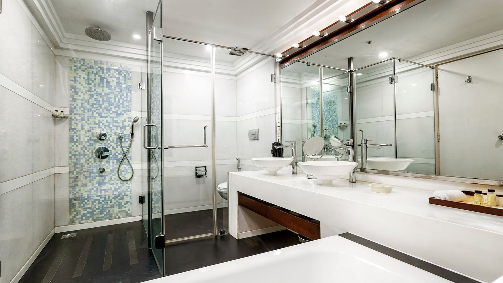 an overview of the bathroom with a bathtub in view inside deluxe suite - Caravela Beach Resort Goa