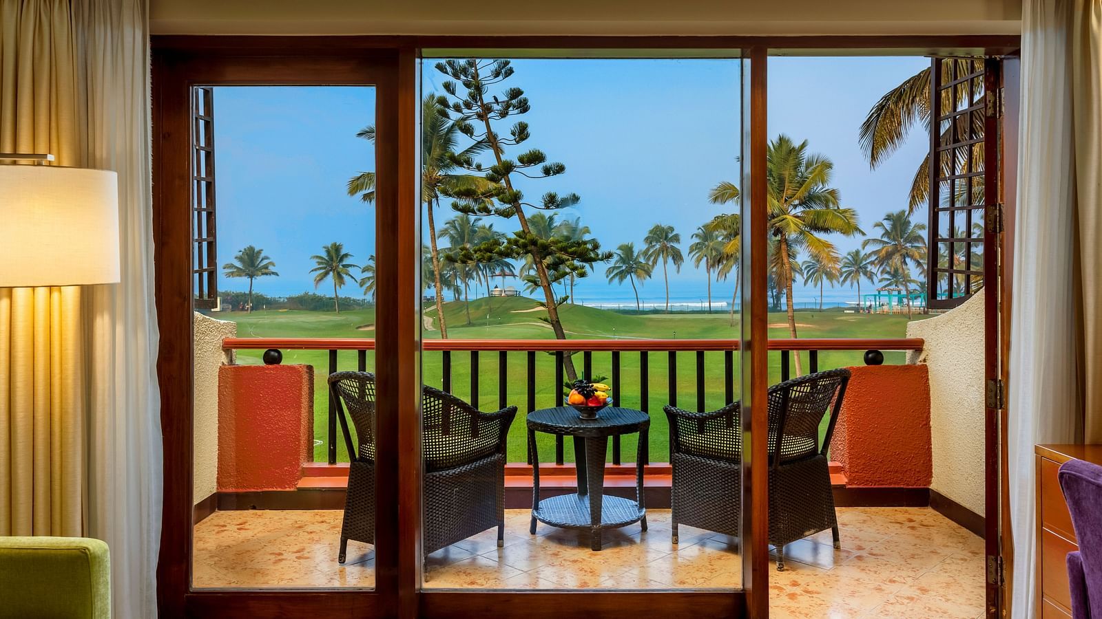 two chairs and a table in the balcony of Ocean front view - Caravela Beach Resort Goa