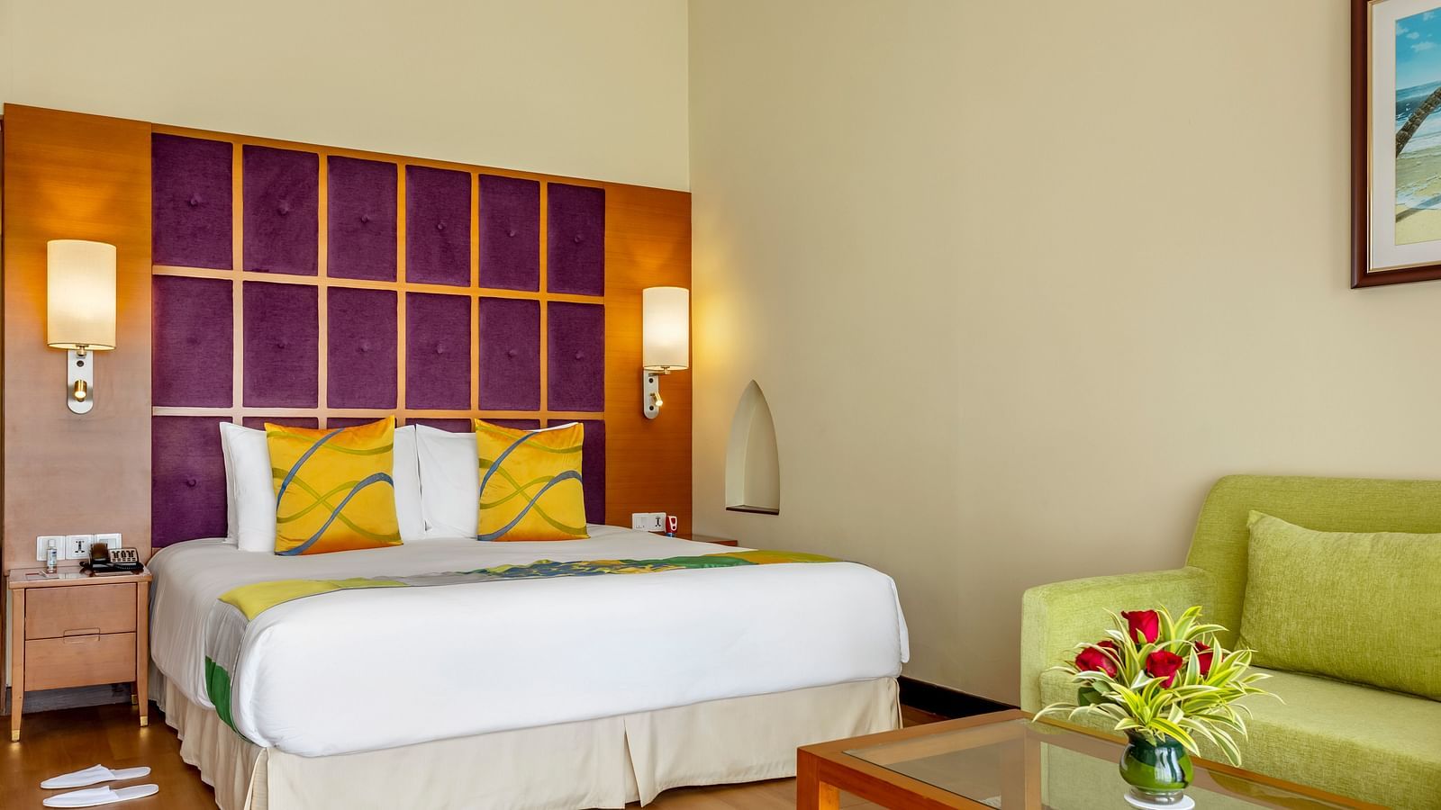 a double bed with side tables and lamps inside Ocean front view - Caravela Beach Resort Goa