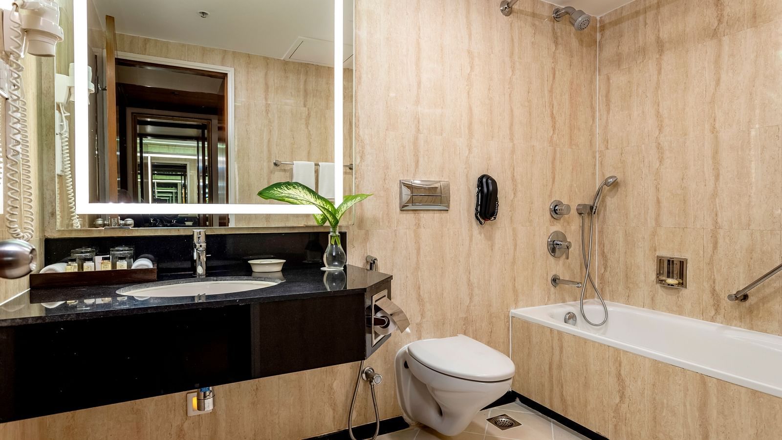 overview of the bathroom with sink area, a bathtub inside Superior Room - Caravela Beach Resort Goa