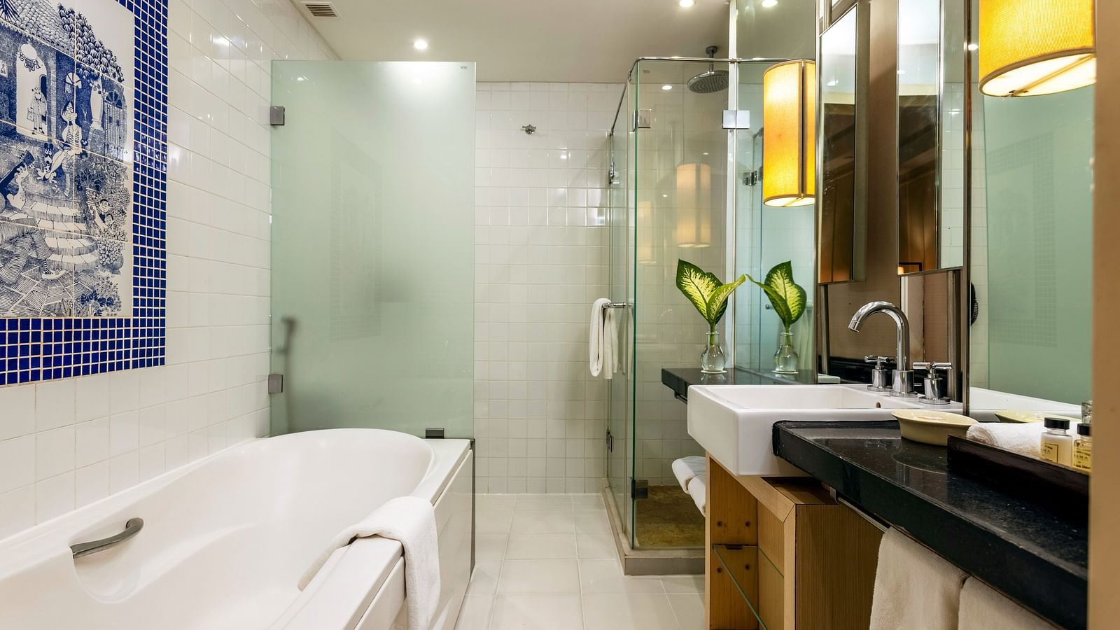 overview of the bathroom with the bathtub in view inside one of the rooms - Caravela Beach Resort Goa
