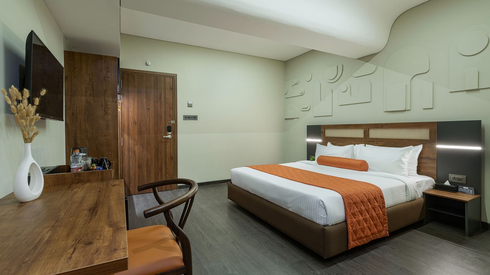 Comfortable Tangerine Room with an in-room safe, a study table and chair alongwith plush beds making a promising stay.