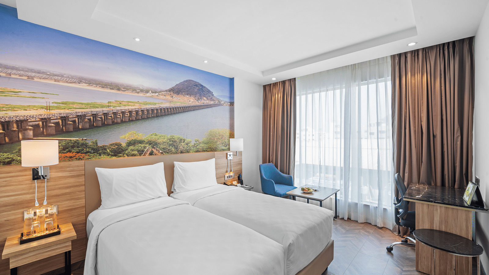 An image of twin beds of a room at Grand Vijayawada by GRT Hotels.