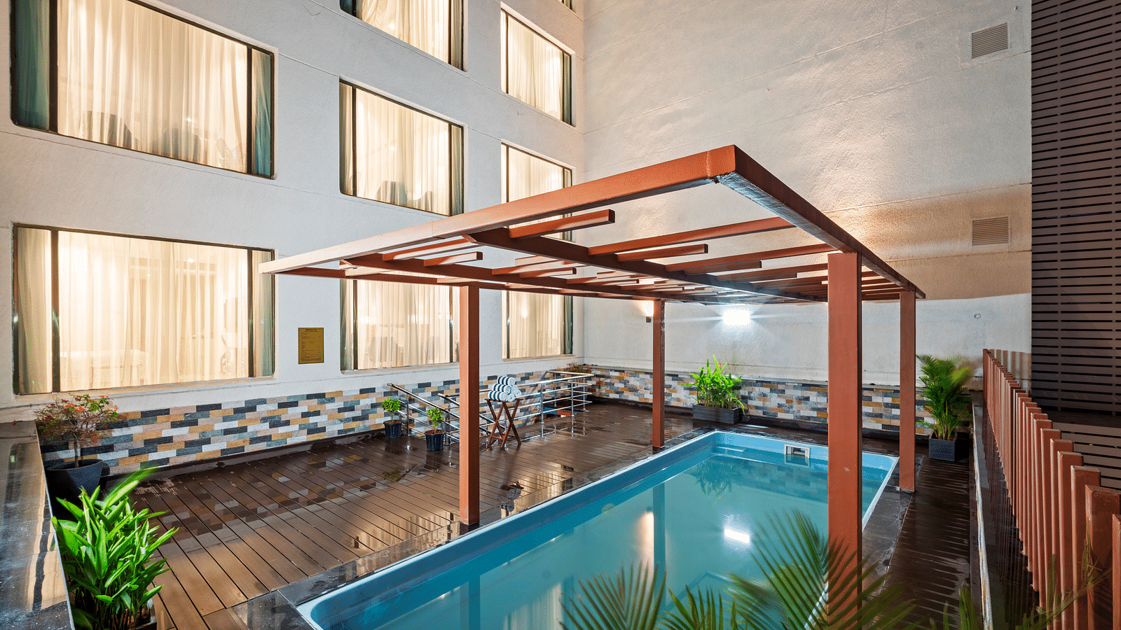 An image of a swimming pool at night of Grand Vijayawada by GRT Hotels.