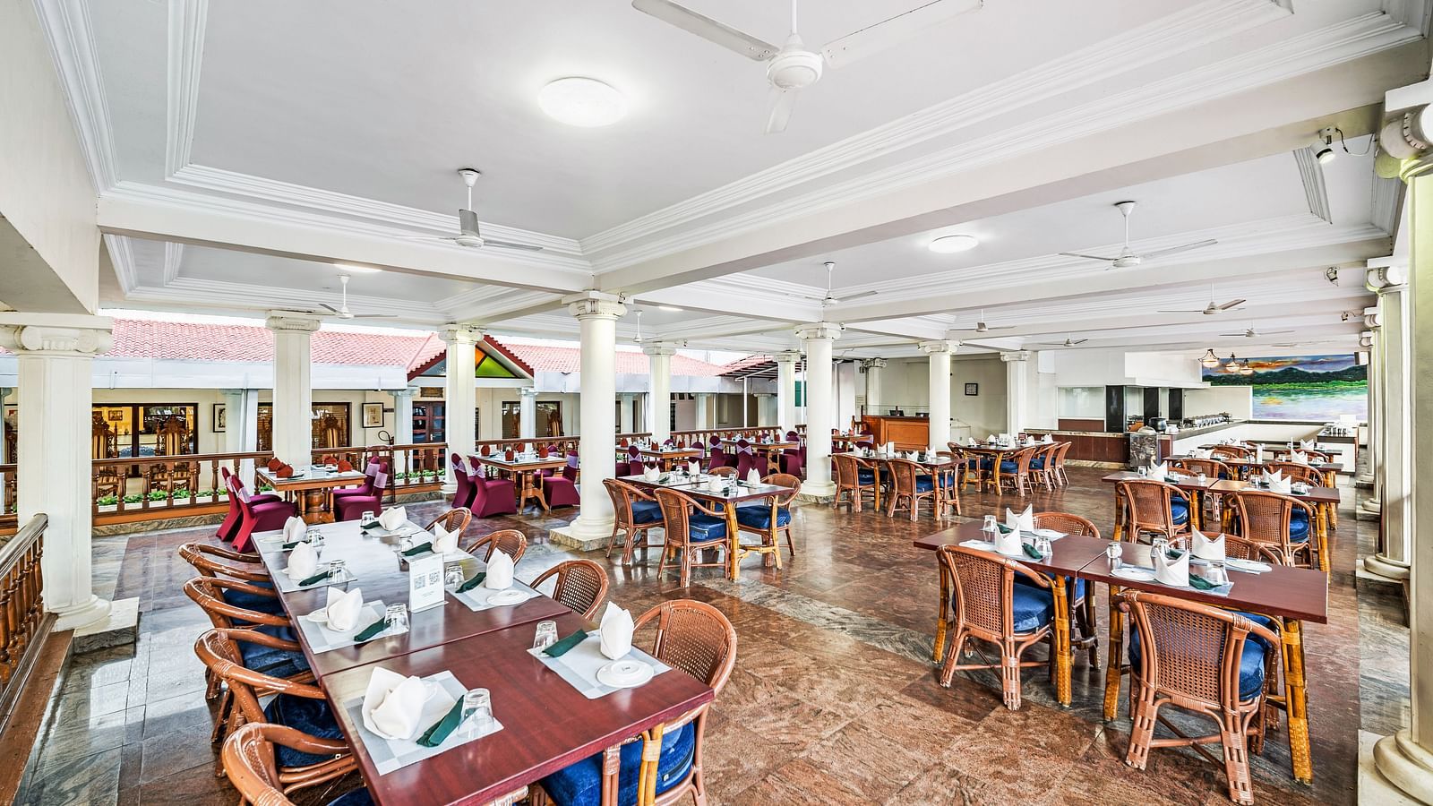 An image of the outdoor dining area featuring tables and chair at GReaT Trails River View Resort Thanjavur By GRT Hotels