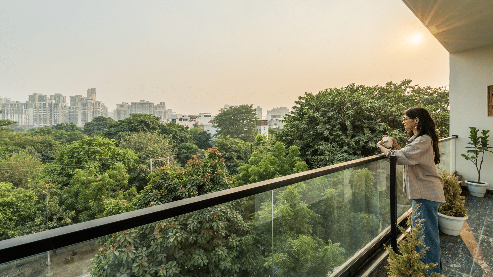 Guest enjoying the scenic city view from the hotel's private balcony.