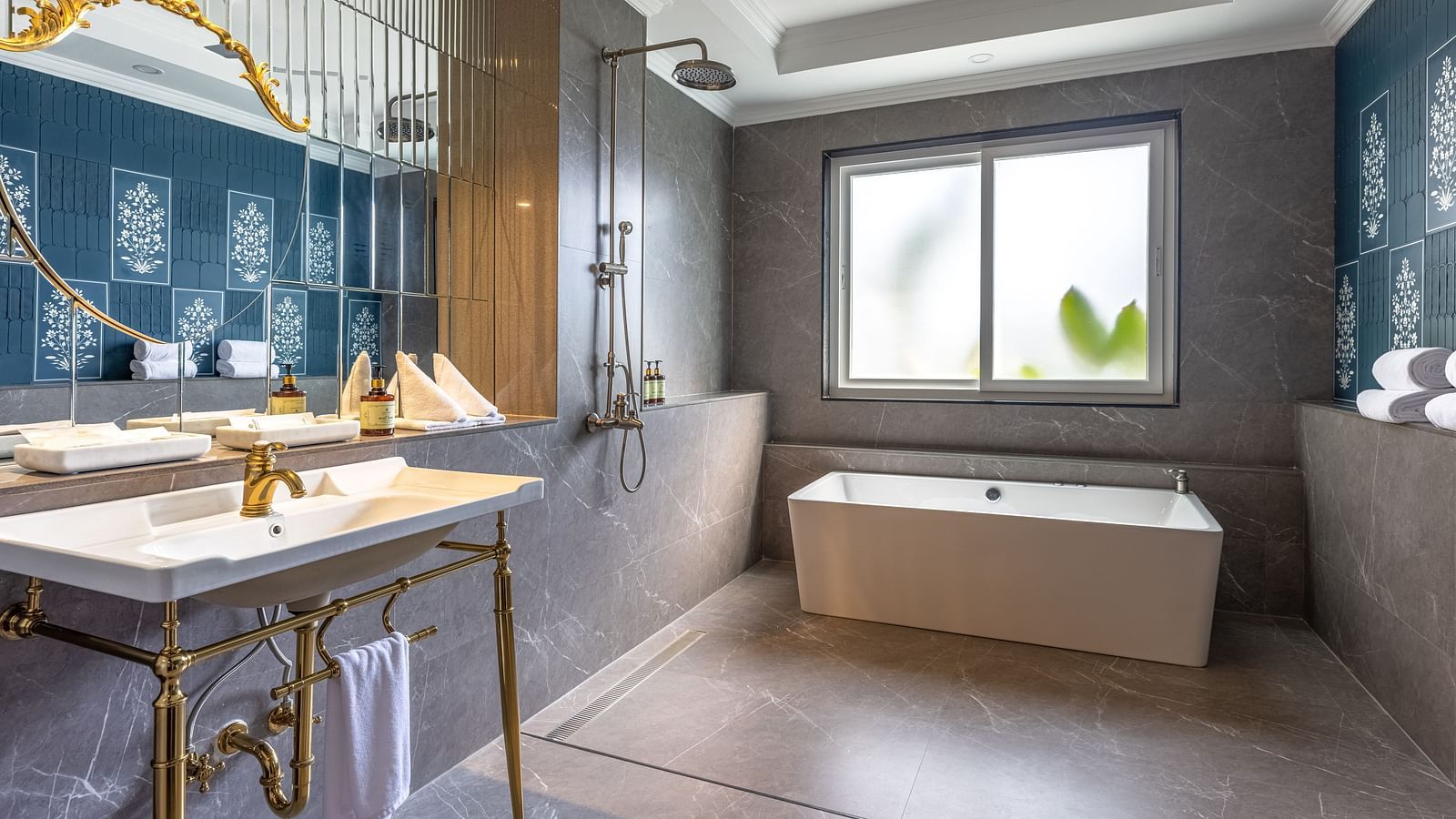 Modern bathroom with bathtub and gold fittings at MAYFAIR Palm Beach Resort, Gopalpur-on-Sea