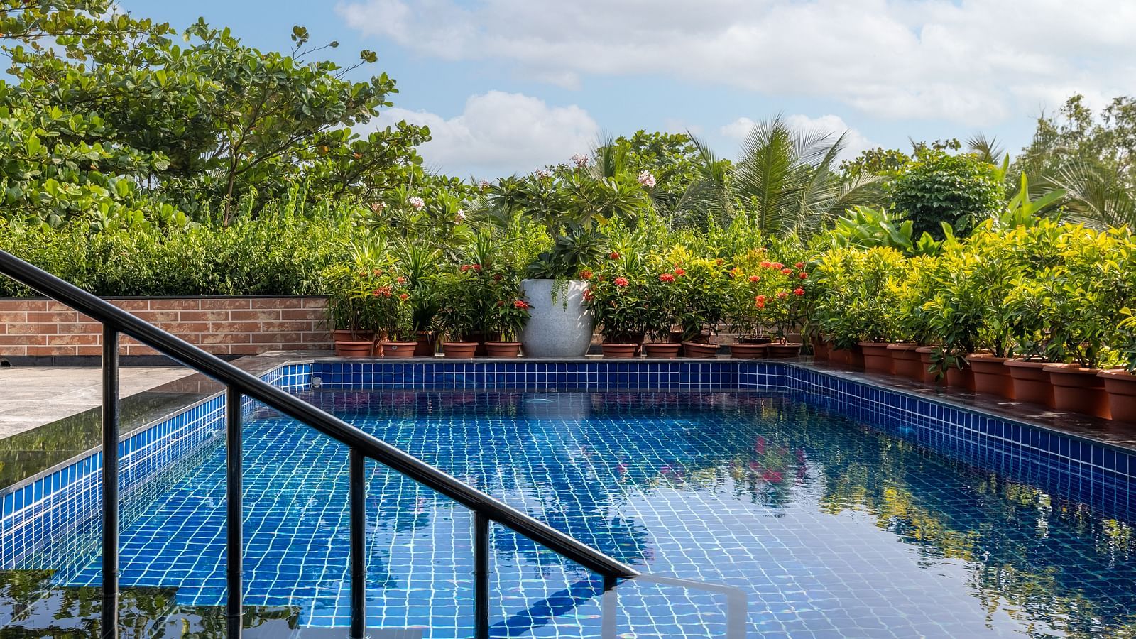Tranquil pool area with lush surroundings at MAYFAIR Palm Beach Resort, Gopalpur-on-Sea