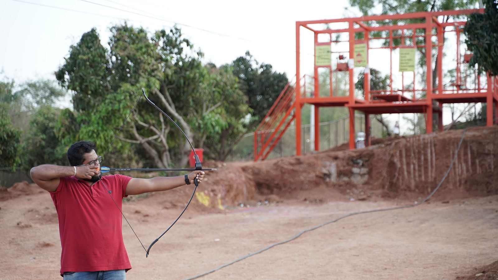 A person with a bow and an arrow at Ravishing Retreat in Bangalore aiming