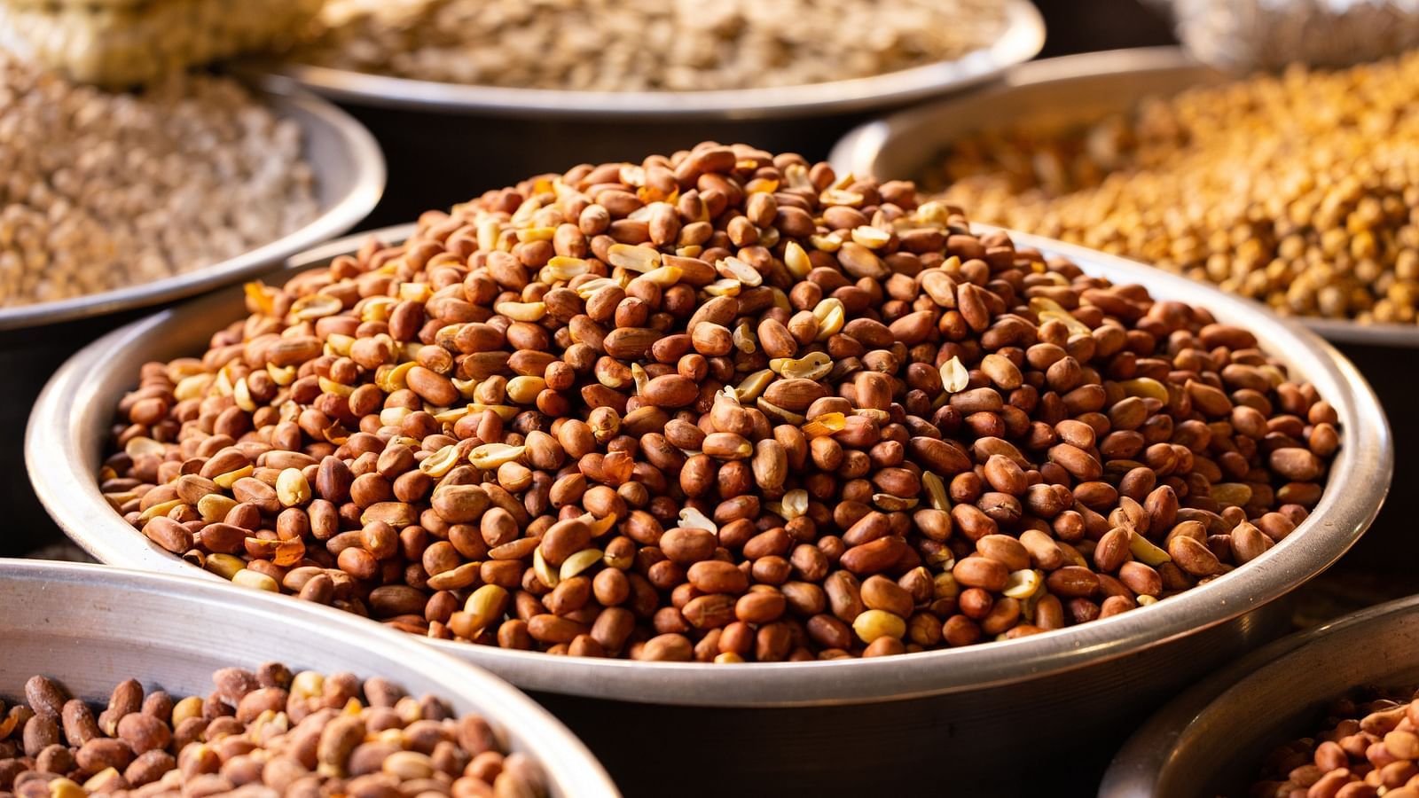 nuts kept in a large bowl that is on sale at a market 