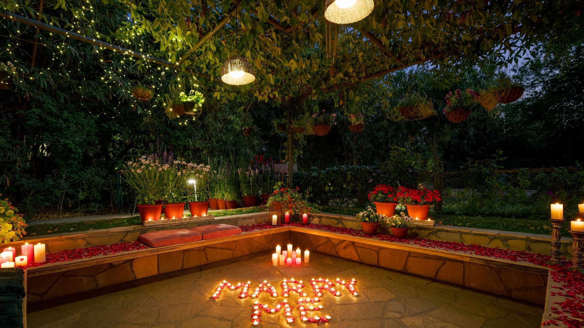 Outdoor seating area decorated with candles and lights for a romantic evening at Karma Chalets.