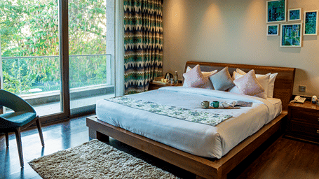 An overview of a bedroom with the balcony door in view - Karma Lakelands.