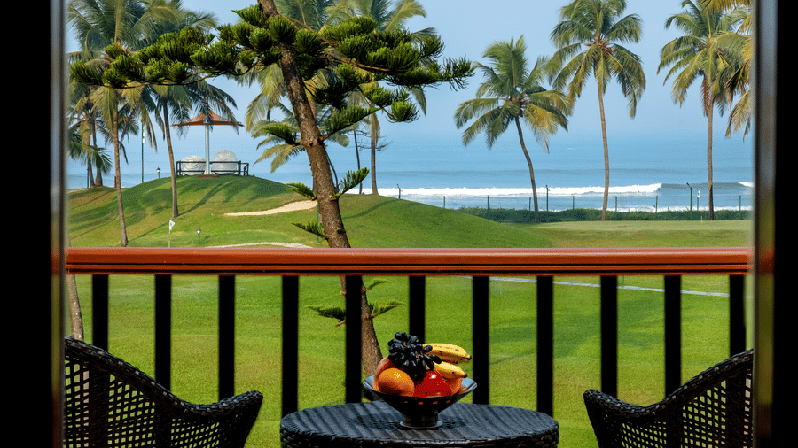 two chairs and a table in the balcony of Ocean front view room - Caravela Beach Resort Goa