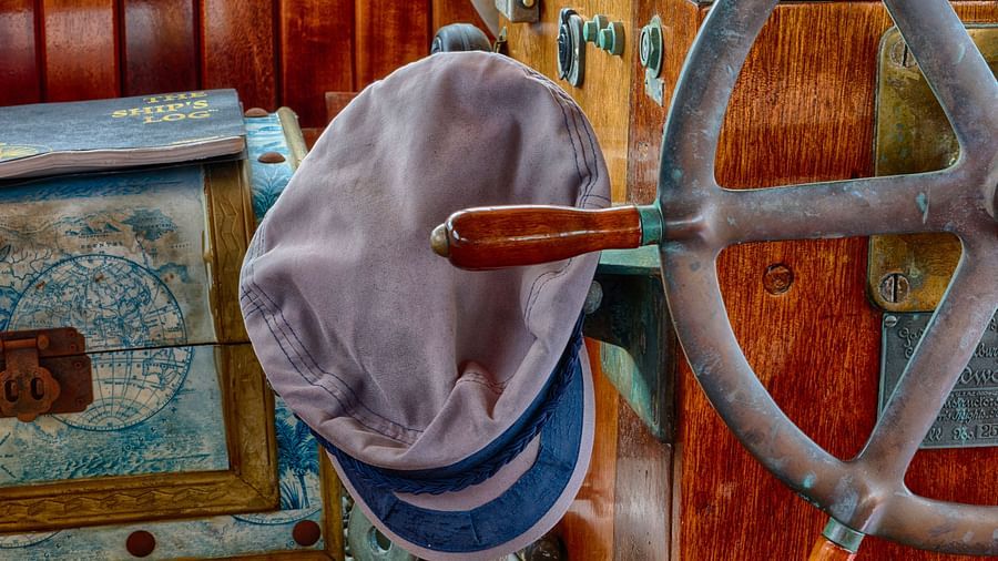 Close-up of a boat’s steering wheel, cap, and equipment at the Casa Morada's dock.