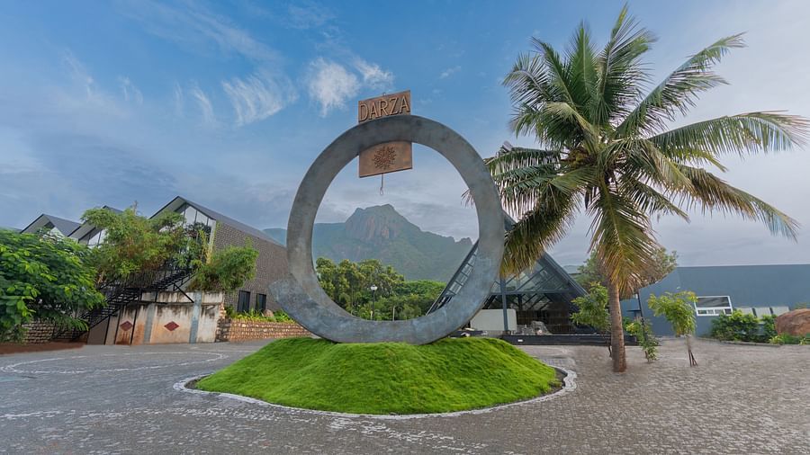 entrance featuring the logo of darza resorts on a ring like structure with clear blue skies in the background