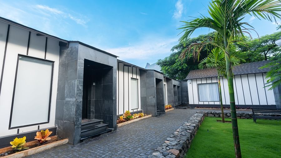 facade image of the garden view room with a pathway besides it - Darza Resorts