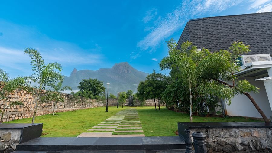 exteriro image of the love letter with a huge green lawn with mountain views in the background - Darza Resorts