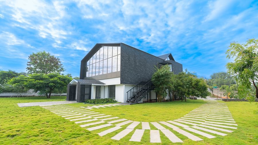 image of the love letter complex with a pathway made of tiles in front of it with clear blue skies in the background - Darza Resorts