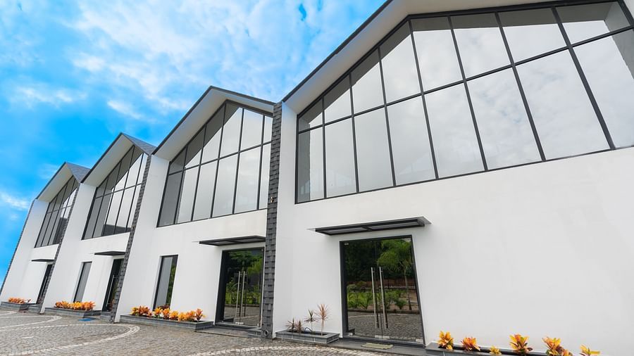a close up of the facade of the blue moon with big glass windows on the upper floor - Darza Resorts