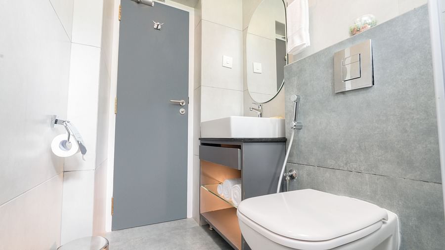 image of a bathroom featuring a commode along with a vanity area in the premium room - Darza Resorts