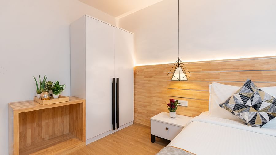 image featuring a side of the double bed in the garden room with a bed side table and wardrobe in the corner - Darza Resorts