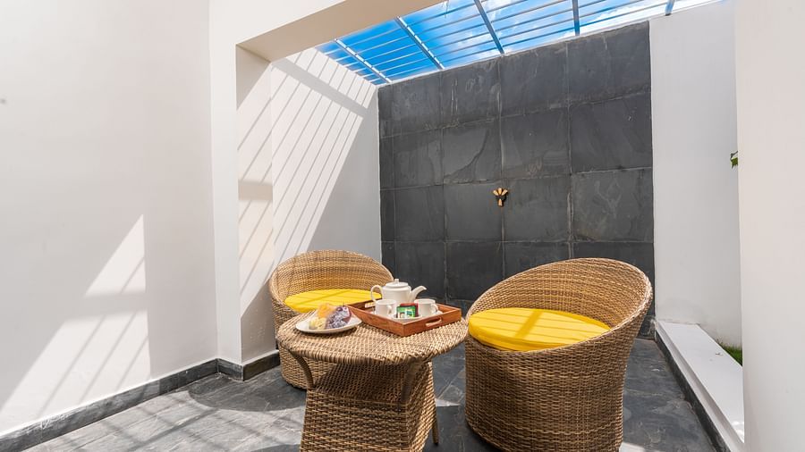 image of the outdoor seating area of the garden room with a sun roof - Darza Resorts