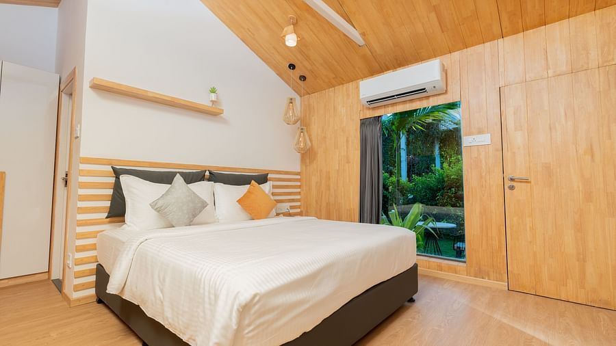 image of a double bed at a premium room with a huge window with amazing views - Darza Resorts