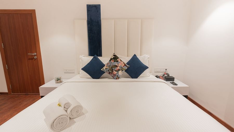 close up image of the king size bed with set cushions in a bedroom of the family villa two bedrooms - Darza Resorts