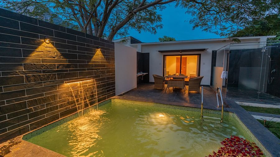 image of the swimming pool in the family villa two bedroom on a late evening with outdoor lights switched on - Darza Resorts