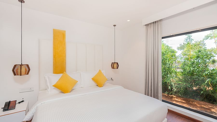 front view image of the double bed with two yello cushions at the family villa two bedroom - Darza Resorts