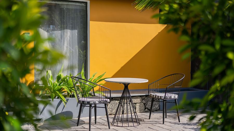 a close up image of the premium room exterior featuring a private sit out area with two chairs and a coffee table - Darza Resorts