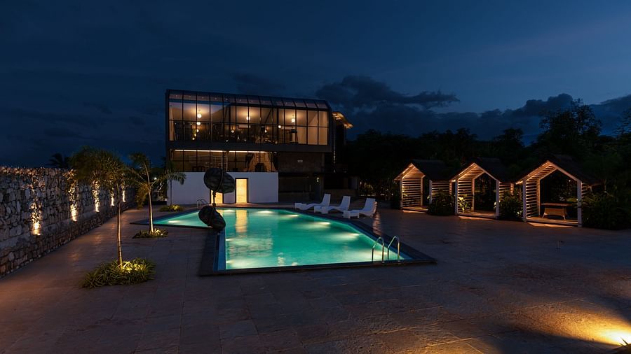 image of the swimming pool on a late evening with exterior lights switched on - Darza Resorts
