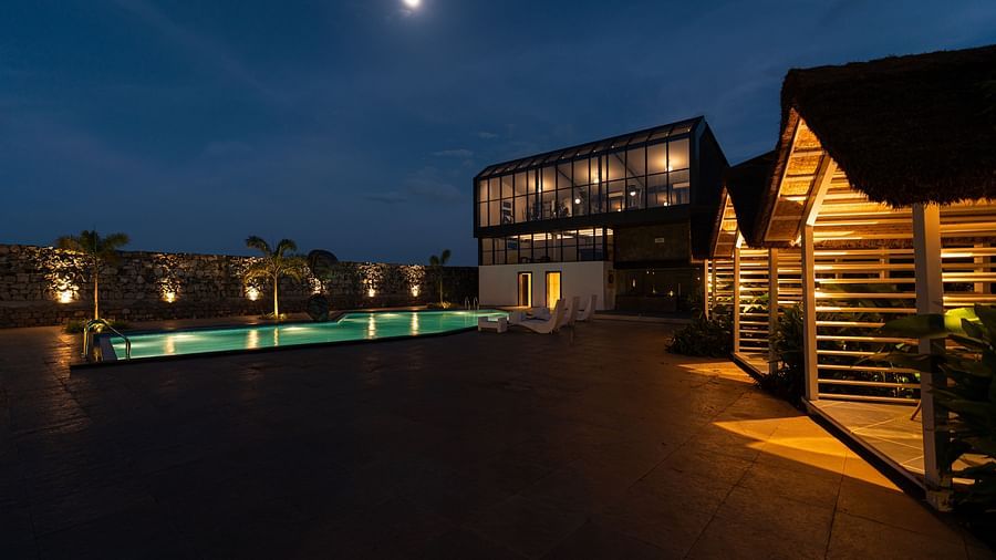 image featuring the poolside covered seating area under the moonlight - Darza Resorts