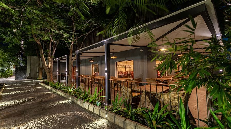 facade image of the mekong restaurant on a late evening along with the stone pathways besides it - Darza Resorts