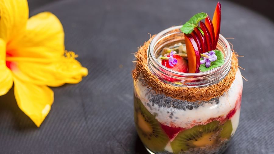 Gamyam Retreat, Kumta - A fruit jar made up of layers and a lily kept near it