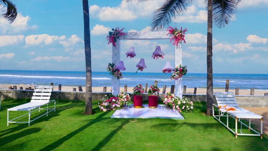 Decorated outdoor space under a blue sky with the sea visible at the backdrop at Grande Bay Resort & Spa.