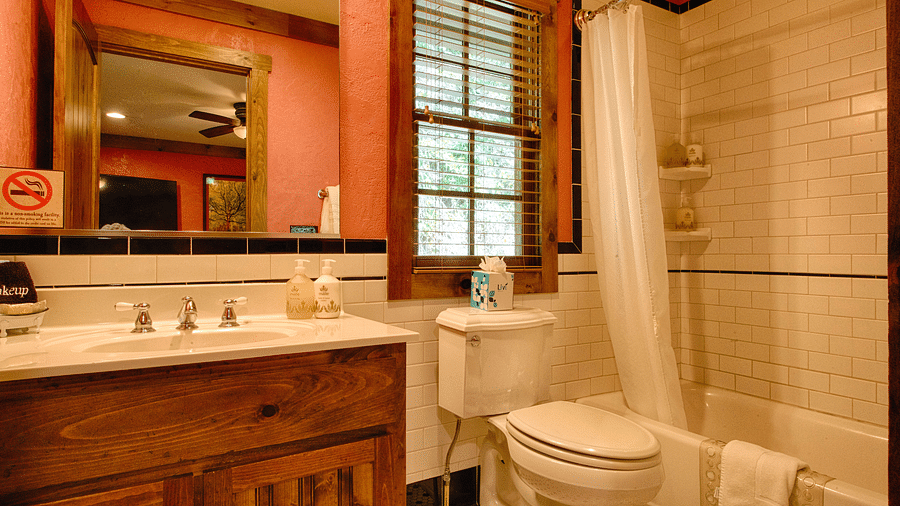 a well-furnished bathroom with a vanity area and a bath tub in the Whiteoak Two - Historic Tapoco Lodge
