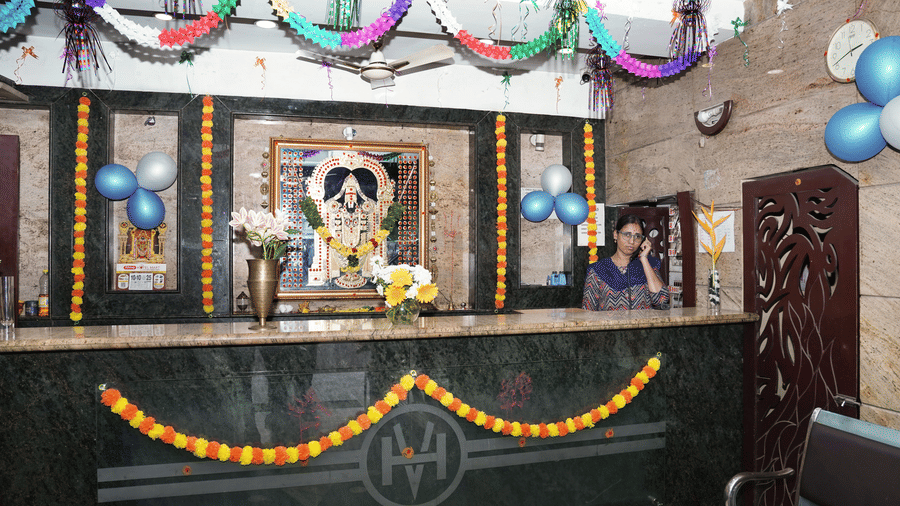 The front desk at Hotel Vikram decorated with garlands and balloons.