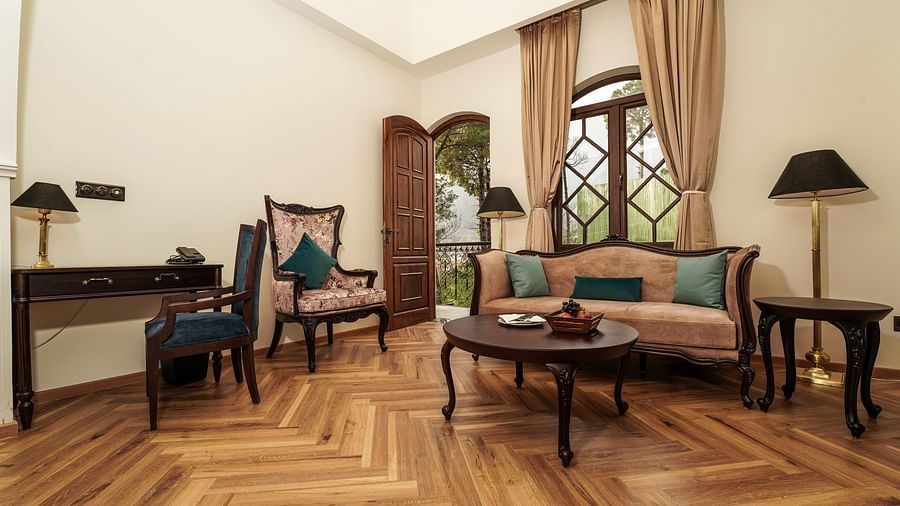 Seating area with a sofa in the living room at INFINITEA Dak Bungalow, Palampur
