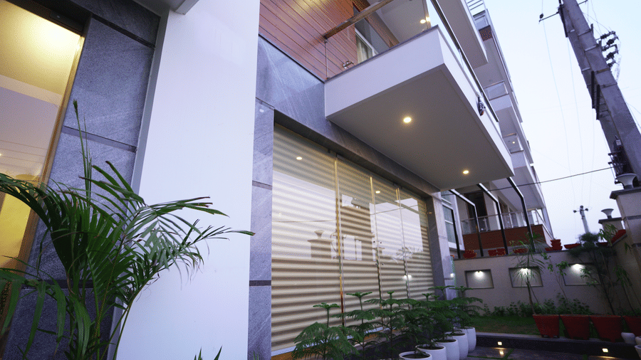 Balcony of Lime Tree Hotel, Pulkit featuring potted plants and shutter panelling.