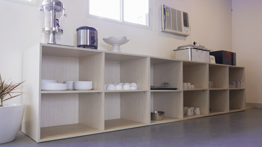 Open shelving unit of Lime Tree Hotel, Pulkit featuring tea and coffee making trays.