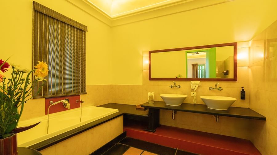 Suite Washroom with a bathtub, mirror and two wash basins.