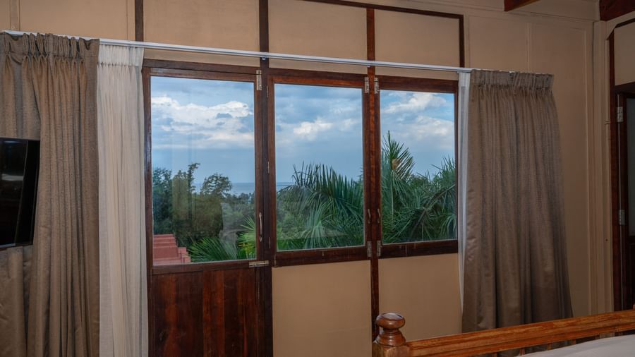 Superior Bedroom  balcony view with curtains.