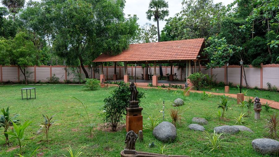 Side view of a large patch of land covered by grass and trees with a resting area