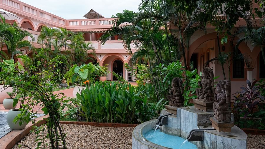 Interior of a Resort property with fountain and trees.