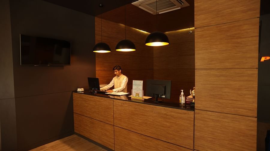 the billing area with a person standing behind the counter looking into his system - Max Hotel, Jabalpur