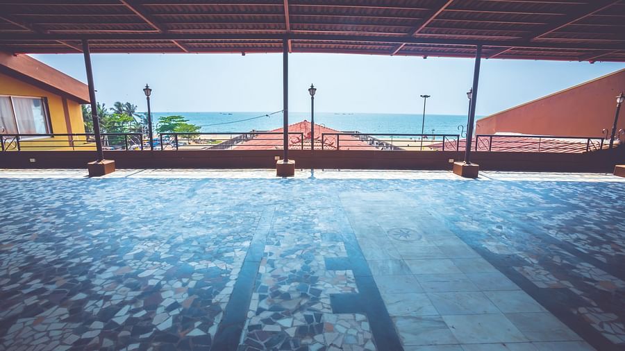 A view of an outdoor event space with sea views at Paradise Isle Beach Resort, Udupi covered using terracotta tiles