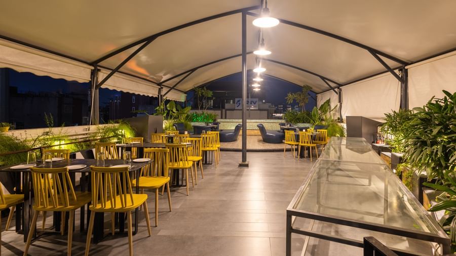 Rooftop dining setup in the Pravasa Cafe at Pravasa Stay Vijay Nagar, Indore.
