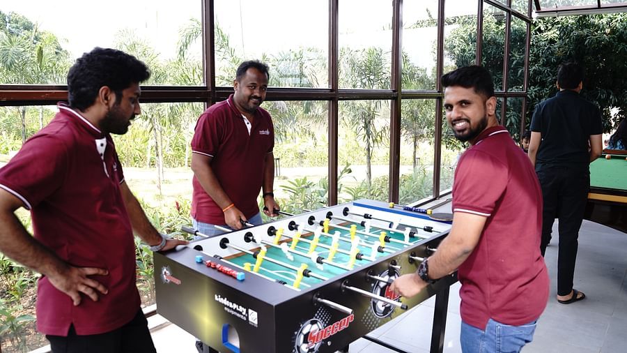 three people playing foosball at Ravishing Retreat during daytime